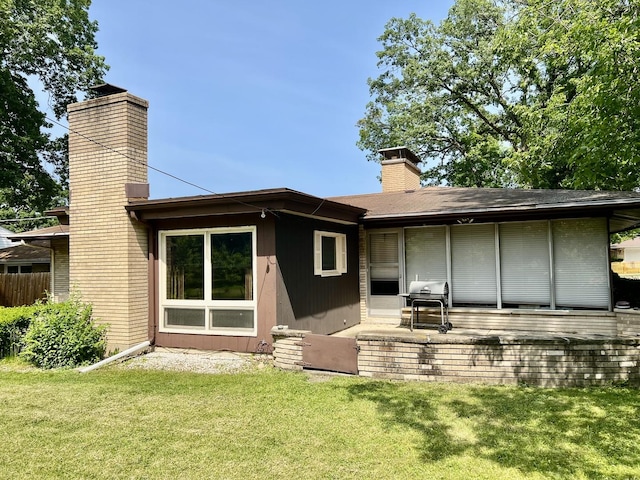 336 Flossmoor Ave, Waukegan, IL 60085 - back of property with a chimney and a patio area