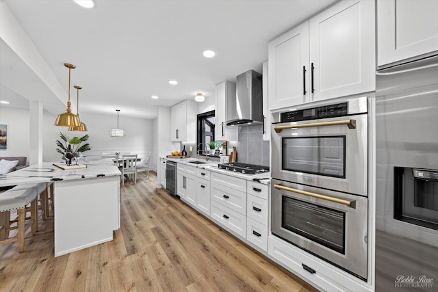 111 Mayberry Ct, Rolling Meadows, IL 60008 - kitchen featuring stainless steel appliances, wall chimney range hood, white cabinets, recessed lighting, and decorative light fixtures