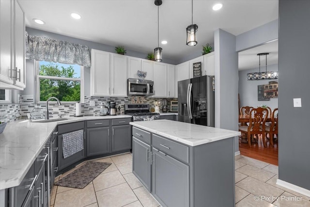 28909 Honeysuckle Ct, Lakemoor, IL 60051 - kitchen with appliances with stainless steel finishes, gray cabinetry, tasteful backsplash, light tile patterned floors, and recessed lighting