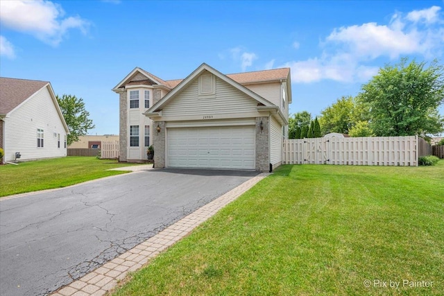 28909 Honeysuckle Ct, Lakemoor, IL 60051 - view of front of home with driveway, an attached garage, brick siding, and a gate