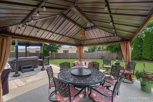 28909 Honeysuckle Ct, Lakemoor, IL 60051 - fenced backyard featuring a hot tub, a gazebo, outdoor dining area, and a patio area