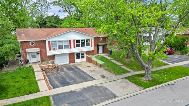 6710 Valley View Rd, Hanover Park, IL 60133 - view of front of home featuring driveway, brick siding, and an attached garage