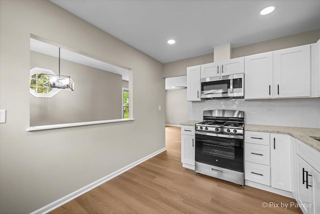 6710 Valley View Rd, Hanover Park, IL 60133 - kitchen with stainless steel appliances, decorative backsplash, light wood-type flooring, white cabinetry, and recessed lighting