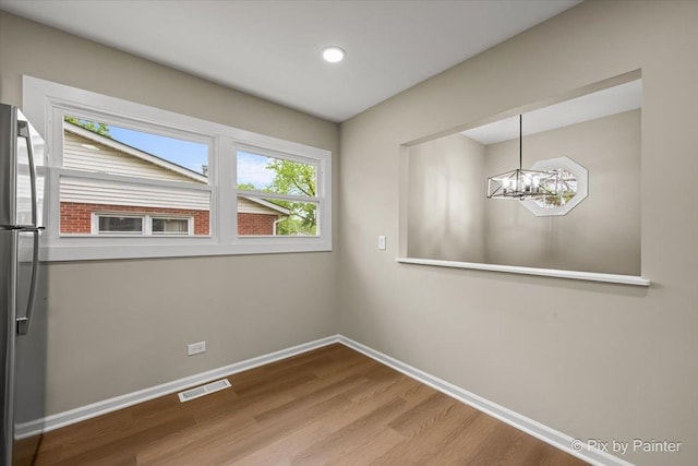 6710 Valley View Rd, Hanover Park, IL 60133 - unfurnished dining area featuring a chandelier, wood finished floors, and recessed lighting