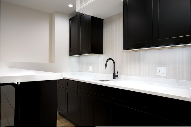 8402 S Carpenter St, Chicago, IL 60620 - kitchen featuring dark cabinets, light stone countertops, and recessed lighting