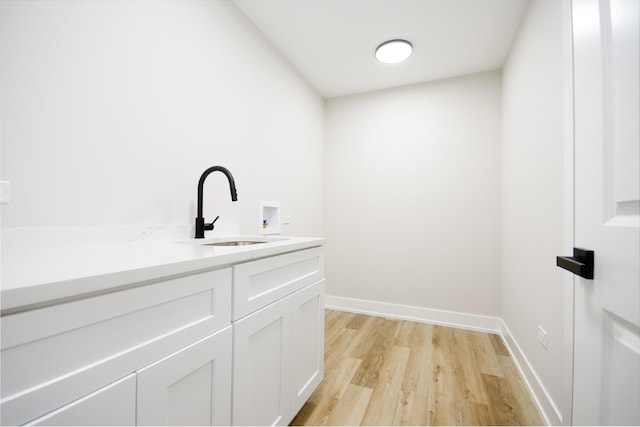 8402 S Carpenter St, Chicago, IL 60620 - laundry room featuring cabinet space, light wood-style floors, and washer hookup