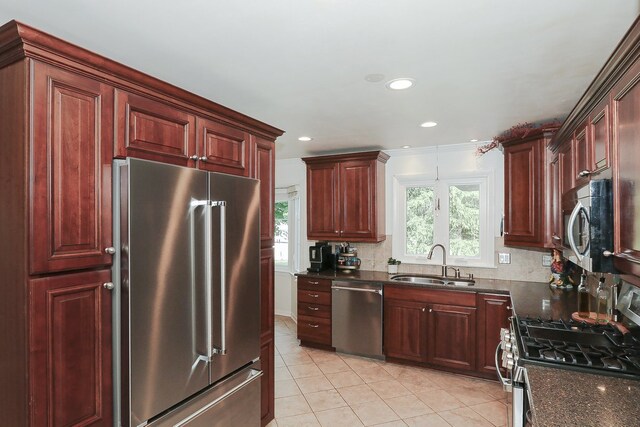 110 Tudor Dr, Barrington, IL 60010 - kitchen with stainless steel appliances, light tile patterned floors, dark stone countertops, dark brown cabinets, and recessed lighting