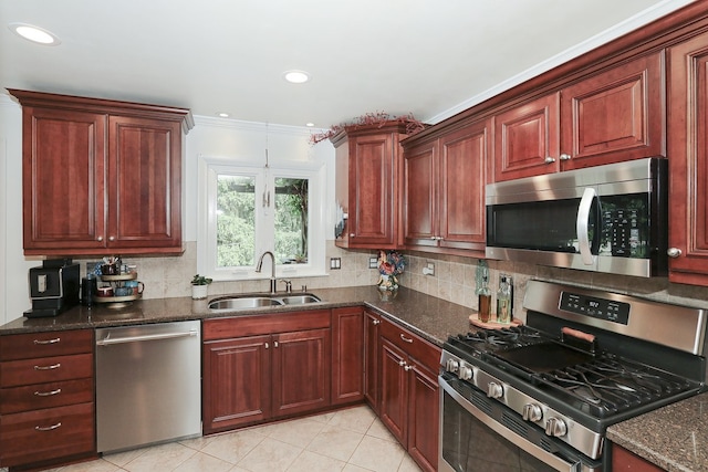 110 Tudor Dr, Barrington, IL 60010 - kitchen featuring stainless steel appliances, backsplash, light tile patterned flooring, crown molding, and dark stone countertops