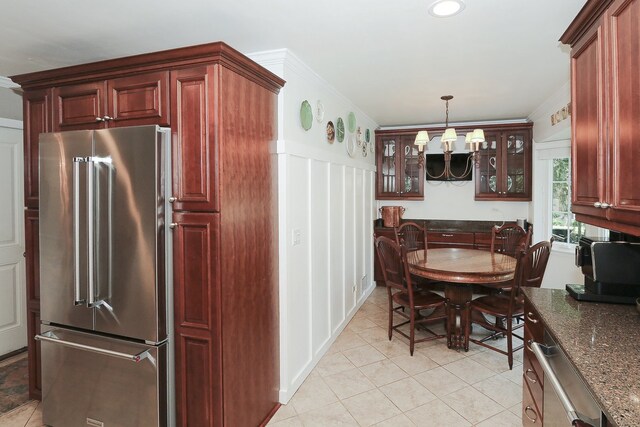 110 Tudor Dr, Barrington, IL 60010 - kitchen featuring high end fridge, a chandelier, light tile patterned floors, glass insert cabinets, and a decorative wall