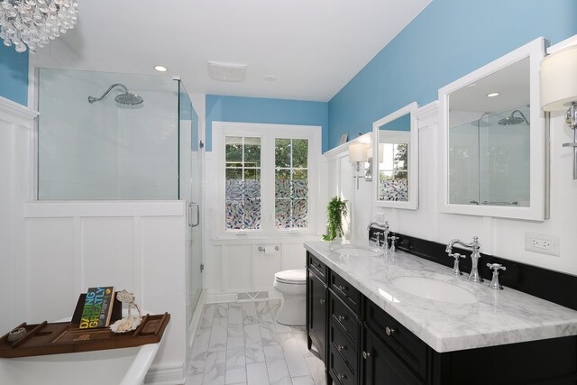 110 Tudor Dr, Barrington, IL 60010 - full bathroom with a stall shower, double vanity, marble finish floors, wainscoting, and a decorative wall