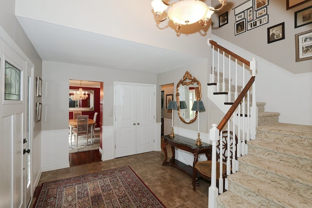 110 Tudor Dr, Barrington, IL 60010 - tiled entryway with a chandelier, stairway, and a wainscoted wall