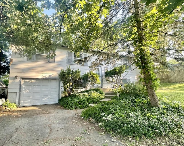 115 Walnut Dr, Streamwood, IL 60107 - obstructed view of property featuring an attached garage and driveway
