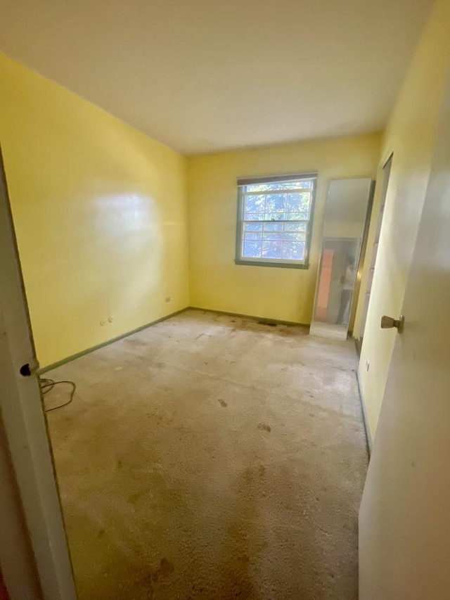 115 Walnut Dr, Streamwood, IL 60107 - carpeted empty room with baseboards