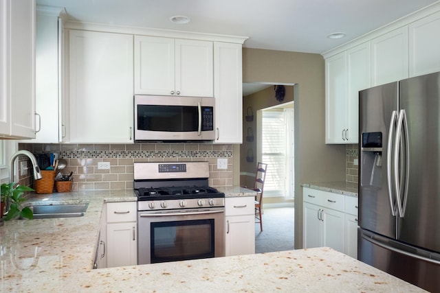 1903 Ronzheimer Ave, Saint Charles, IL 60174 - kitchen with stainless steel appliances, light stone counters, decorative backsplash, and white cabinets