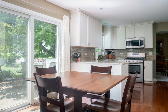 1903 Ronzheimer Ave, Saint Charles, IL 60174 - kitchen with appliances with stainless steel finishes, white cabinetry, backsplash, wood-type flooring, and recessed lighting