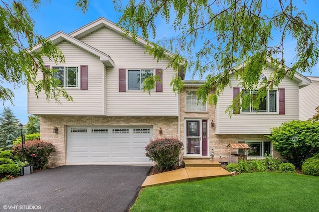 16501 W Montauk Dr, Lockport, IL 60441 - view of front of house with brick siding, asphalt driveway, a front yard, and a garage