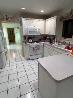 872 Mason Ln, Des Plaines, IL 60016 - kitchen with white appliances, light tile patterned floors, light countertops, white cabinets, and recessed lighting