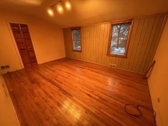 872 Mason Ln, Des Plaines, IL 60016 - empty room with hardwood / wood-style flooring and lofted ceiling