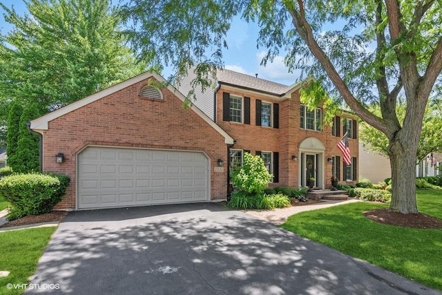 2325 Fairfax Rd, Saint Charles, IL 60174 - colonial house with brick siding, driveway, a garage, and a front lawn