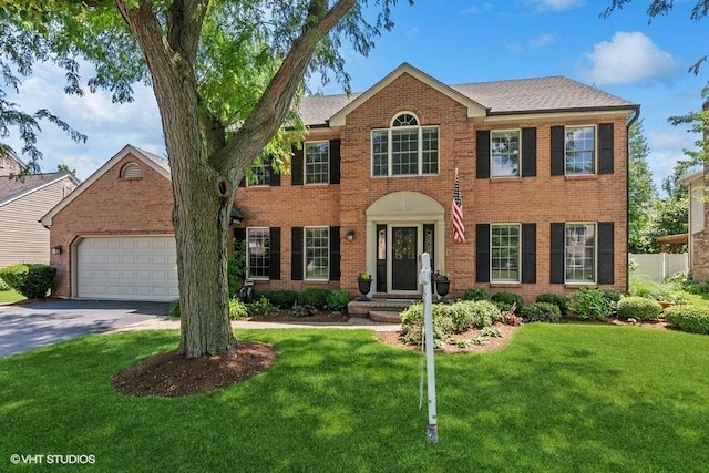 2325 Fairfax Rd, Saint Charles, IL 60174 - colonial house with brick siding, a front lawn, driveway, and an attached garage