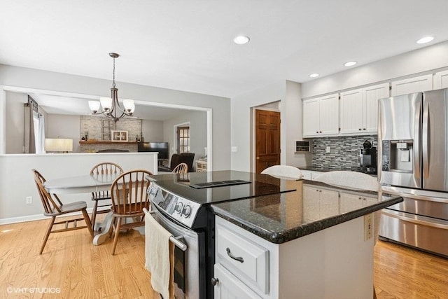 2325 Fairfax Rd, Saint Charles, IL 60174 - kitchen featuring appliances with stainless steel finishes, white cabinetry, light wood-type flooring, a chandelier, and recessed lighting