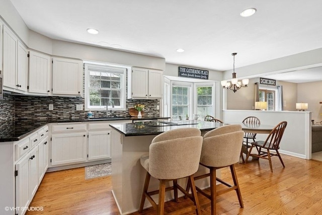 2325 Fairfax Rd, Saint Charles, IL 60174 - kitchen with backsplash, a kitchen island, white cabinetry, and recessed lighting