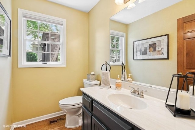2325 Fairfax Rd, Saint Charles, IL 60174 - half bath featuring vanity, plenty of natural light, and wood finished floors