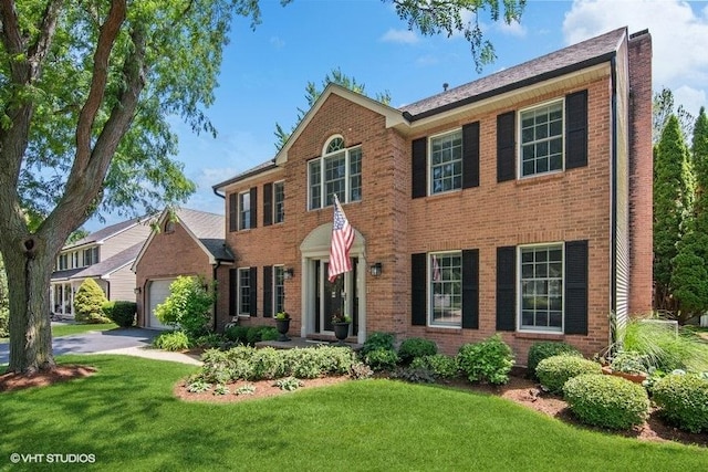 2325 Fairfax Rd, Saint Charles, IL 60174 - view of front facade featuring brick siding, a front yard, and a garage