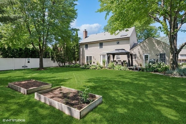 2325 Fairfax Rd, Saint Charles, IL 60174 - rear view of house with a gazebo, a garden, and a chimney