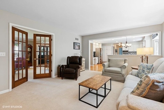 2325 Fairfax Rd, Saint Charles, IL 60174 - living room featuring french doors, a chandelier, and healthy amount of natural light