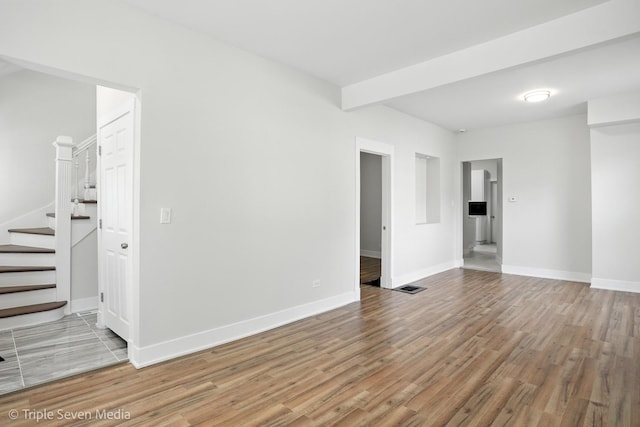 3425 W Carroll Ave, Chicago, IL 60624 - spare room with wood finished floors and stairs