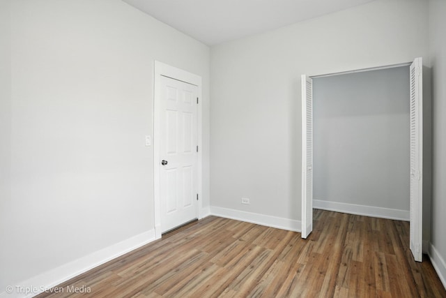 3425 W Carroll Ave, Chicago, IL 60624 - unfurnished bedroom with wood finished floors and a closet