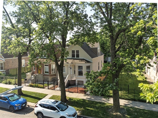 3425 W Carroll Ave, Chicago, IL 60624 - view of front facade featuring a fenced front yard and stucco siding