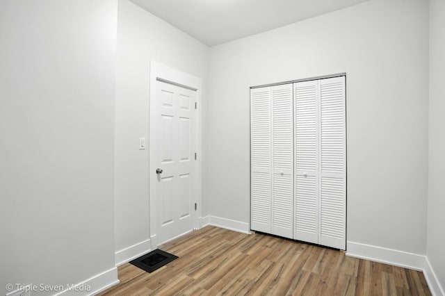 3425 W Carroll Ave, Chicago, IL 60624 - unfurnished bedroom with wood finished floors and a closet