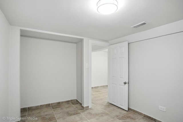 3425 W Carroll Ave, Chicago, IL 60624 - empty room featuring baseboards and tile patterned flooring