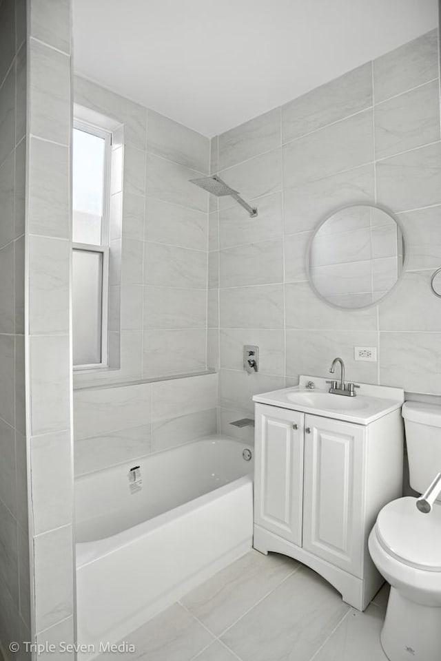 3425 W Carroll Ave, Chicago, IL 60624 - full bath with shower / washtub combination, vanity, tile walls, and tile patterned flooring