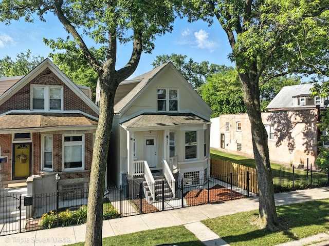 3425 W Carroll Ave, Chicago, IL 60624 - view of front facade with brick siding, a fenced front yard, and a gate