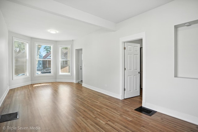 3425 W Carroll Ave, Chicago, IL 60624 - spare room with wood finished floors and beamed ceiling