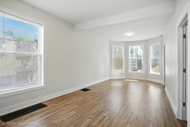 3425 W Carroll Ave, Chicago, IL 60624 - empty room with wood finished floors and beamed ceiling