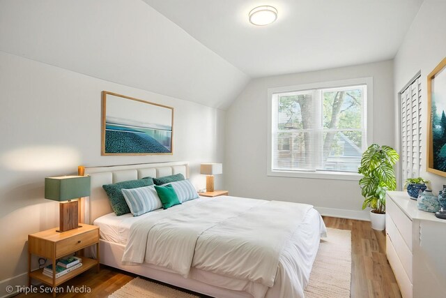 3425 W Carroll Ave, Chicago, IL 60624 - bedroom featuring vaulted ceiling and light wood-style flooring