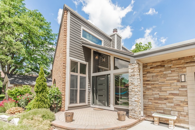 908 Claremont Dr, Downers Grove, IL 60516 - entrance to property with stone siding and a chimney