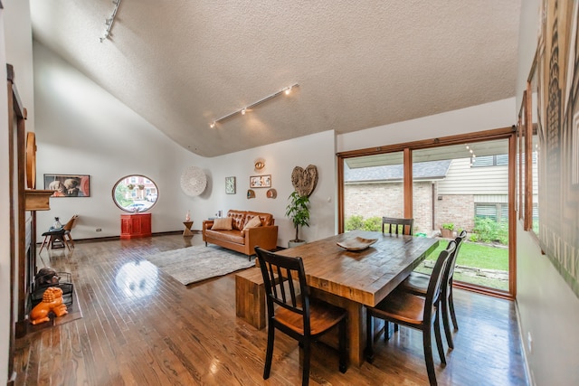908 Claremont Dr, Downers Grove, IL 60516 - dining space with track lighting, hardwood / wood-style flooring, a textured ceiling, and lofted ceiling