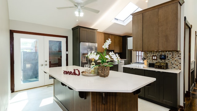 908 Claremont Dr, Downers Grove, IL 60516 - kitchen featuring stainless steel appliances, lofted ceiling, light countertops, decorative backsplash, and a ceiling fan