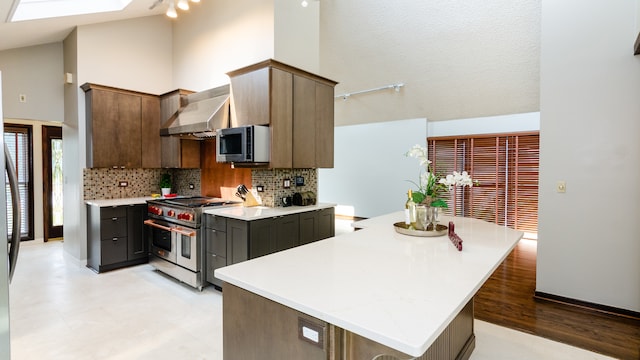 908 Claremont Dr, Downers Grove, IL 60516 - kitchen featuring stainless steel appliances, wall chimney range hood, backsplash, light countertops, and track lighting