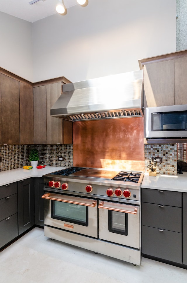 908 Claremont Dr, Downers Grove, IL 60516 - kitchen with appliances with stainless steel finishes, wall chimney range hood, tasteful backsplash, and light countertops
