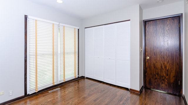 908 Claremont Dr, Downers Grove, IL 60516 - unfurnished bedroom featuring dark wood-type flooring and baseboards