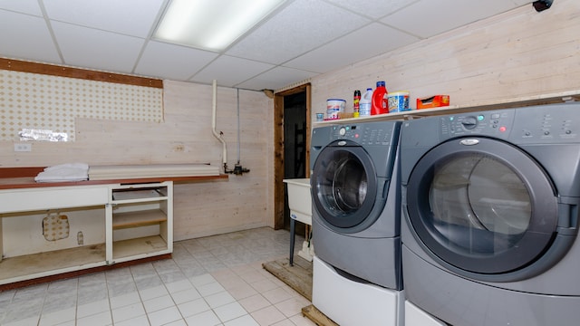 908 Claremont Dr, Downers Grove, IL 60516 - laundry area with wooden walls, washing machine and dryer, light tile patterned floors, and a workshop area
