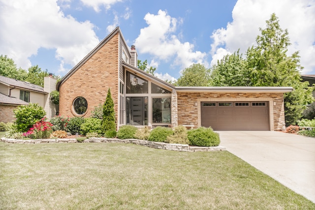 908 Claremont Dr, Downers Grove, IL 60516 - mid-century modern home featuring an attached garage, concrete driveway, a front yard, a chimney, and brick siding