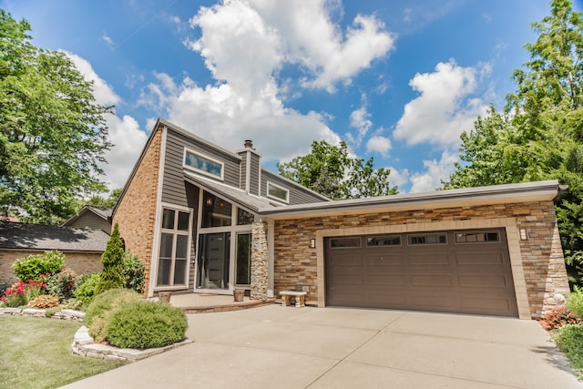 908 Claremont Dr, Downers Grove, IL 60516 - mid-century inspired home featuring driveway, stone siding, a garage, and a chimney
