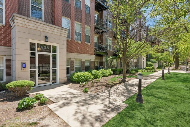 1255 N Orleans St Unit 1103, Chicago, IL 60610 - doorway to property with brick siding and a yard